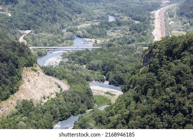 A Highway In A Picturesque Mountainous Area Along A Clear Blue River. Sochi, Krasnaya Polyana, Russia.