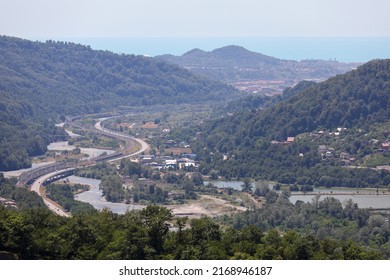 A Highway In A Picturesque Mountainous Area Along A Clear Blue River. Sochi, Krasnaya Polyana, Russia.