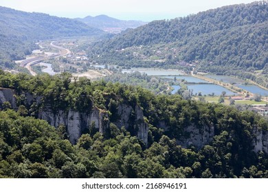 A Highway In A Picturesque Mountainous Area Along A Clear Blue River. Sochi, Krasnaya Polyana, Russia.