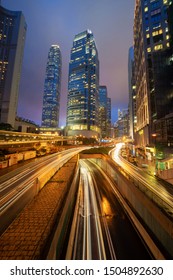 Highway Road In Hong Kong Downtown. Financial District And Business Centers In Smart City And Technology Concept. Skyscraper And High-rise Office Buildings At Night. International Finance Center