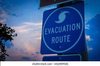 A highway road sign directs weather evacuees to safety.