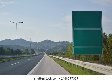 Highway And  Road Signs At Cloudy Day.