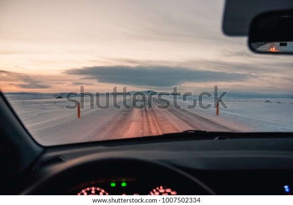 Highway road with snow and sunrise at winter in\
Iceland - wild snowy\
blizzard