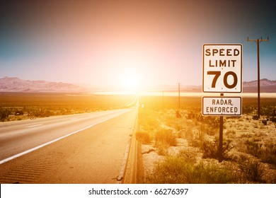 Highway road to sunset. 70 MPH speed limit sign.