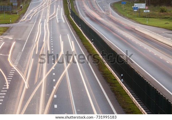 A highway road - view from above with car lights\
at a long exposure