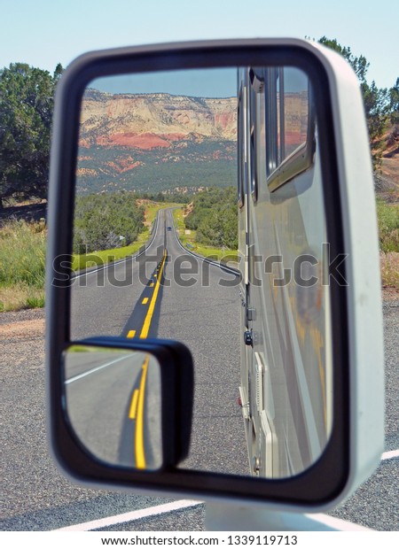 Highway seen in\
the mirror of RV in Nevada,\
USA