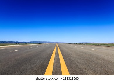 highway in steppe against a blue sky,long road stretching out into the distance