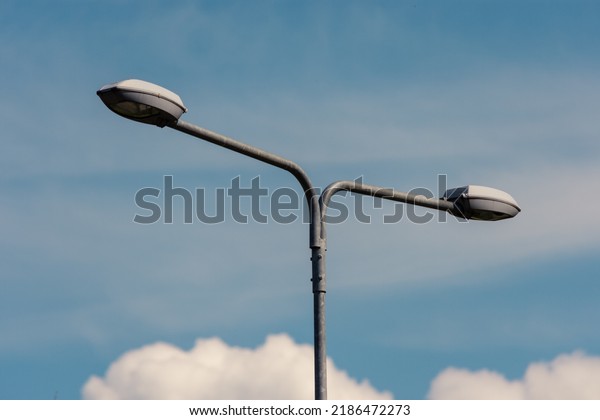 Highway street lamp divided in two to illuminate\
both lanes