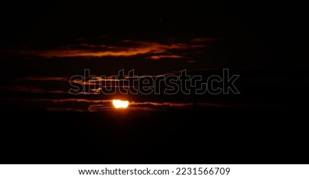Highway at sunset. Dramatic twilight sky, midnight sun, starlight, moonlight. Dark atmospheric landscape. Panoramic view, copy space, art. Dangerous driving, loneliness, peace, freedom concepts