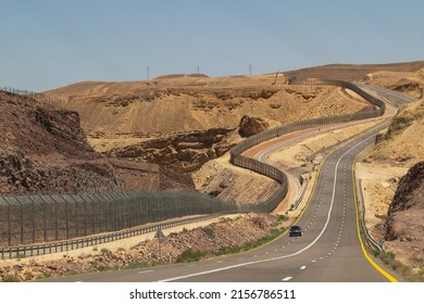 Highway through the Negev Desert on the border with Egypt showing the fence between the countries in Southern Israel
 - Shutterstock ID 2156786511