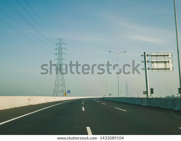 Highway\
Toll Road in indonesia asia with clear blue\
sky
