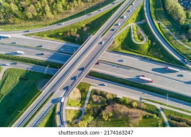 Highway traffic on a multilevel crossing on A4 international motorway, the part of freeway around Krakow, Poland. Aerial view from above  - Shutterstock ID 2174163247
