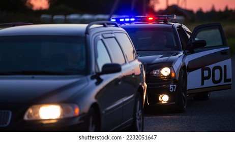 Highway Traffic Patrol Car Pulls over Vehicle on the Road. Male Police Officer Approaches and Asks Driver for License and Registration. Officer of the Law doing Job Professionally. Cinematic Wide Shot - Shutterstock ID 2232051647