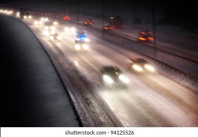 Highway Traffic In Snowstorm At Night With Blurred Motion