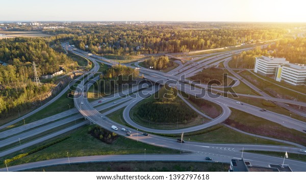 Highway transportation system highway\
interchange at sunset. Summer time green road way.\
\
