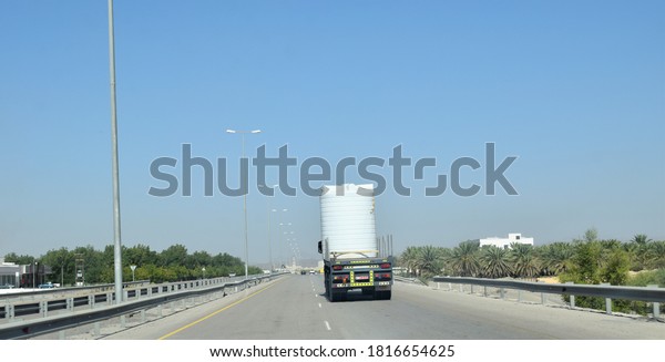 Highway\
transportation with white tank trailer. Oman to nizwa city highway\
road travel. Muscat, Oman :\
17-09-2020