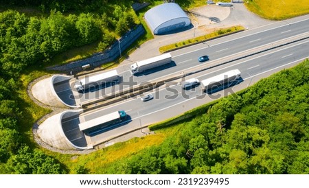 Highway tunnel in mountain. Traffic on the road. Transportation from above. Cars as a source of air pollution.