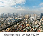 Highway with vehicles. Highrise buildings and residential area. Metro Manila, Philippines.