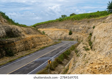 a highway whose road cuts through the hills
