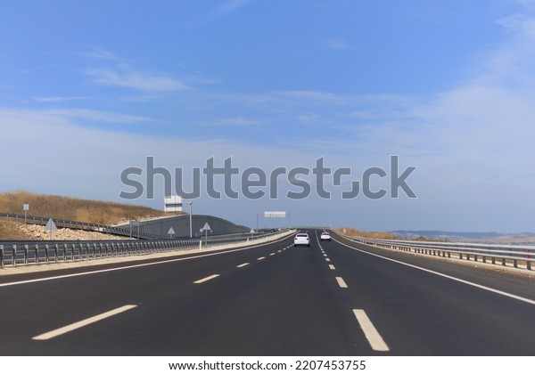 Highway wide road, transport and blue sky with clouds
on a summer day