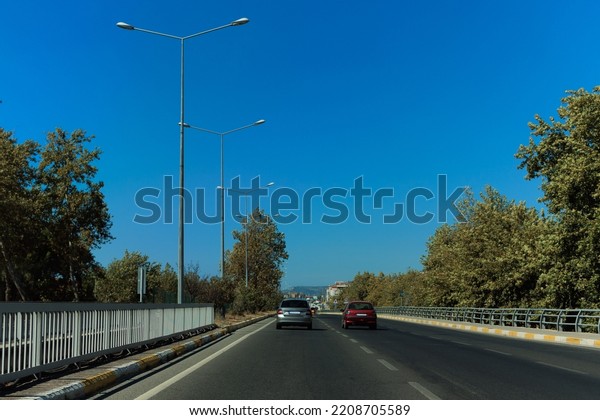 Highway wide road, transport and blue sky with clouds\
on a summer day
