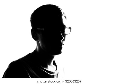Hihg exposure effect on the man face in black silhouette on the white isoalted background
