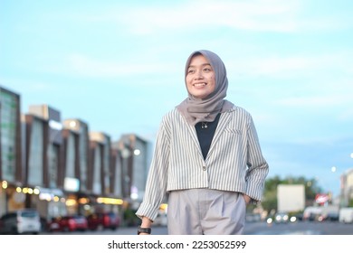 hijab businesswoman walking in the city - Shutterstock ID 2253052599