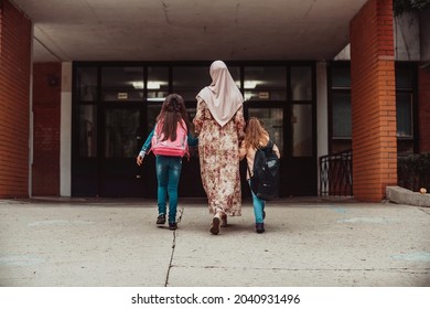 Hijab Muslim Mother Walking Her Kids To School. Selective Focus . High Quality Photo