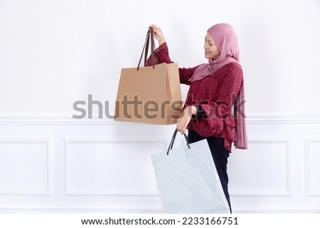 Hijab women with shopping paper bag. Shopping season concept.