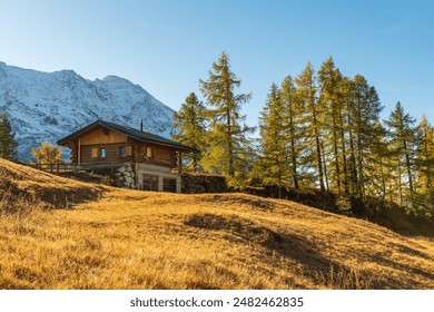 A hike in Lötschental in autumn reveals stunning alpine landscapes with vibrant fall foliage, snow-dusted peaks, serene mountain lakes, and charming Swiss chalets, all under crisp, clear skies - Powered by Shutterstock