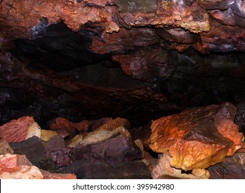 A Hike Through The Leidarendi Lava Cave In Iceland. The Contact With Hot Magma Has Made The Rock Acquire Bizarre Colors.