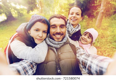 Hike, Travel, Tourism And People Concept - Happy Family With Backpacks Taking Selfie And Hiking