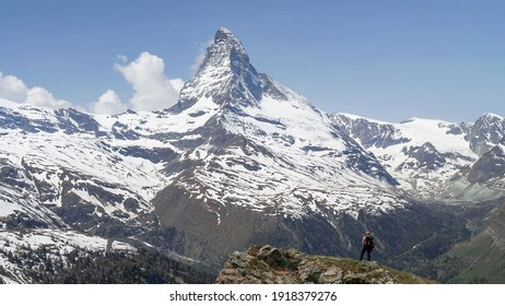 a hiker admiring the matterhorn mountain in zermatt, switzerland