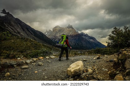 Hiker Advances In The Middle Of Torres Del Paine National Park.