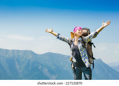 Hiker with backpack enjoying valley view from top of a mountain - Powered by Shutterstock