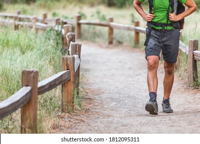 Hiker with backpack walking on hiking path trail in nature woods. Crop of man's legs with shoes on summer travel. - Shutterstock ID 1812095311