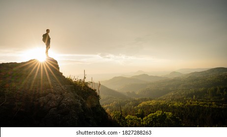 Hiker, Backpacking On Top Of A Mountain Cliff. Dreamy Dramatic Sunset Composite. Landscape Taken In Lusatian Mountains With Wide Panorama. Concept: Adventure, Art, Travel, Hike, Outdoors And Sports. 