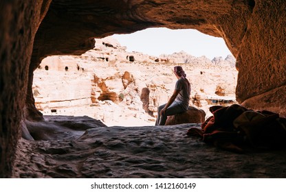 
Hiker in black on the rocky peak. Man sit on the rock and watch over the beautiful view during a vibrant sunset. Petra, Jordan. UNESCO world heritage site and one of The 7 Wonders of the World - Powered by Shutterstock