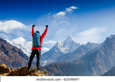 Hiker cheering elated and blissful with arms raised in the sky after hiking. Everest base camp trek - Shutterstock ID 425598697