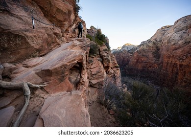 Hiker Climbs Up Ledge Along Angels Landing Trail