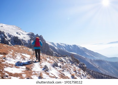 
The Hiker Climbs To The Top Of The Mountain Covered In Snow.
