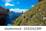 Hiker couple on alpine meadow with panoramic view of majestic mount Hochalmspitze in High Tauern National Park, Carinthia, Austria. Idyllic hiking trail in Austrian Alps. Wanderlust paradise Mallnitz