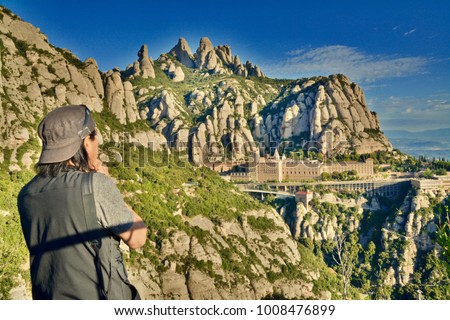 Hiker Enjoys the Spirituality Mountainview Above the Montserrat Abbey. Spectacular Views of Catalan's landscape. Benedictine monastery of Santa Maria de Montserrat is 45 km north of Barcelona, Spain
