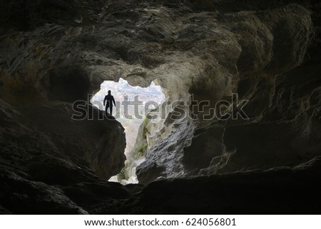  Hiker explore a beautiful cave and watch out of the tunnel.