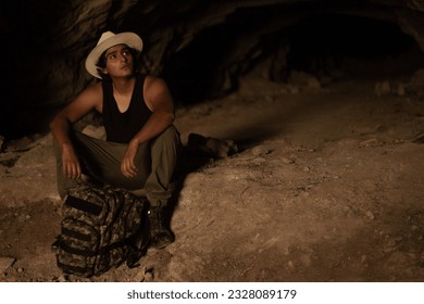 hiker explorer rests inside a cave in the mountains of Guanajuato, Mexico