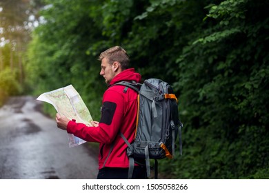 Hiker in a forest using map - Powered by Shutterstock