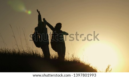 Similar – 2 junge Frauen sitzen auf der Wiese und sehen in die Ferne