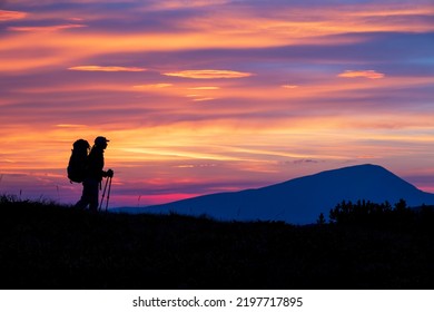 Hiker Girl Silhouette On The Sunset.  Scenic View On The Mountain Trail