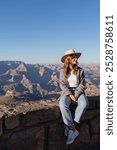 hiker girl sitting on the edge of grand canyon, enjoy view, hiking in the grand canyon national park during spring