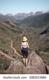 Hiker Girl Wearing Sporty Clothes On The Top Of A Mountain In Pyrenees Valley - Woman Back Portrait Enjoying The Sun  - Adventure Holidays Lifestyle